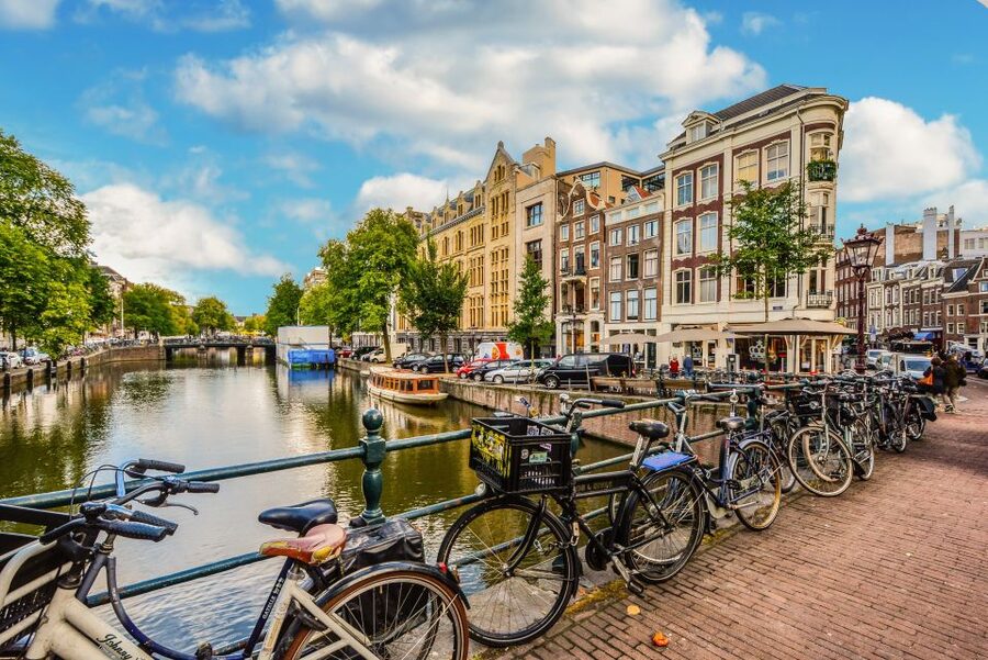 From Brussels: Cheese, Clogs & Windmills Amsterdam Day Trip - Amsterdam begins with a panoramic bus tour